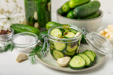 Freshly-salted homemade cucumbers in a jar on a wooden background. pickled cucumbers with dill,garlic and pepper.canned cucumbers.cucumbers and dill.Recipe of homemade preservations.fermented veggies.
