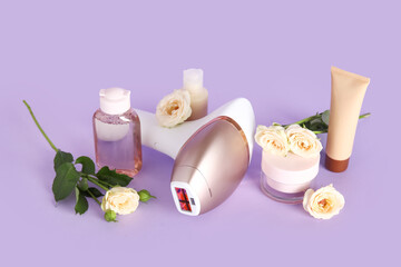 Modern photoepilator with cosmetic products and rose flowers on purple background