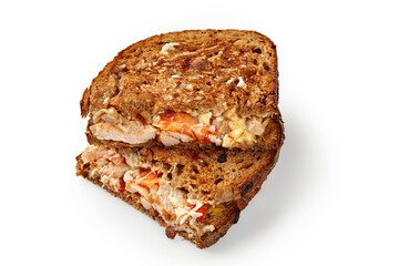 Toasted chicken sandwich with tomatoes, cheese, and mayonnaise on whole wheat bread