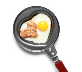 Frying pan with heart-shaped fried egg and bacon on white background, closeup