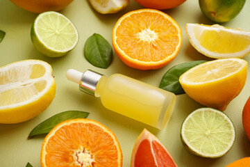 Composition with bottle of essential oil and fresh citrus fruits on color background