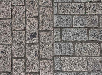 Texture of square paving tile. Pattern of gray and brown sidewalk tiles in the street. Concrete...