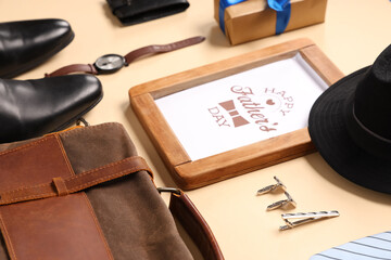 Gift box, greeting card with text HAPPY FATHER'S DAY and man's accessories on yellow background....