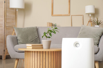 Modern humidifier near coffee table in living room