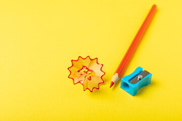 Pencil sharpener on bright colored background. Pencil and pencil shavings. Stationery. School...