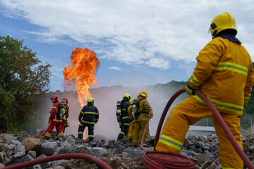 Firefighters are working together to extinguish a fire using water during a fire.