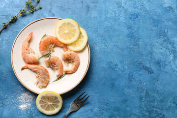 Plate with tasty boiled shrimps, lemon and rosemary on blue background