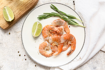 Plate with tasty boiled shrimps, lime and rosemary on grey background