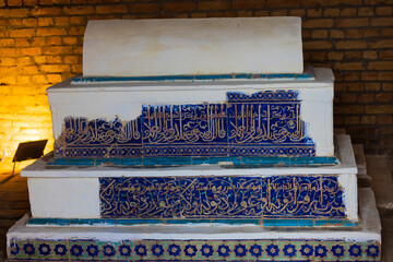 Colorful blue majolica tombstone with quran calligraphy over the grave of an unknown person in the...