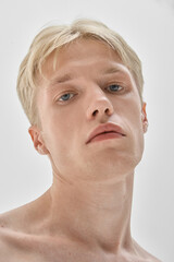 Male portrait with neutral expression and direct gaze symbolizing authenticity and beauty. Concept...