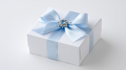 Fototapeta premium Elegant white gift box adorned with a delicate blue ribbon and a decorative brooch, perfect for special occasions, showcasing luxury and thoughtful presentation