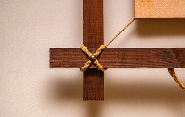 Rustic wooden frame detail with rope knot. The warm wood texture and natural cord create a cozy...