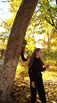      Teenage friends with stage makeup of a mime during an acting lesson celebrate Halloween in the park near the school, act out scenes and having fun