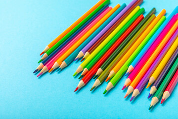 Colored pencils on a bright colored background. Equipment for coloring. Stationery for creativity.Back to school. Flatlay. Children's Creativity and Education. Rainbow.Space for text. Copy space.