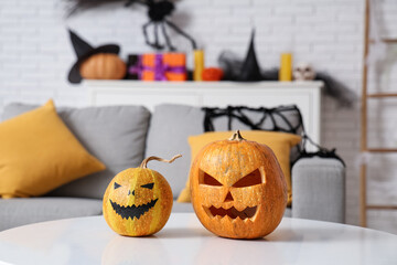 Halloween pumpkins on table in living room, closeup