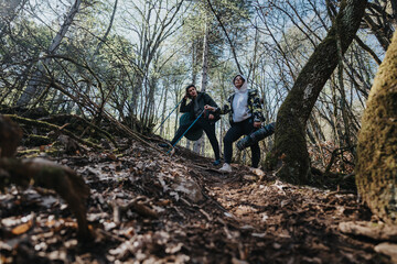 Two individuals hiking together in a serene forest, enjoying physical activities, surrounded by...