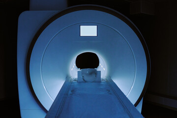 MRI scanner showing patient head entering machine, medical imaging device operating in clinical...
