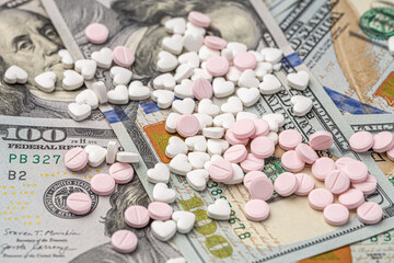 Dollar bill and a set of medicine pills. Rising costs of medical care. Reliefs for buying...