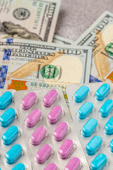 Dollar bill and a set of medicine pills. Rising costs of medical care. Reliefs for buying...