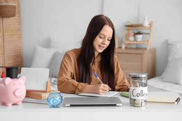 Young woman with savings for education planning her budget at home