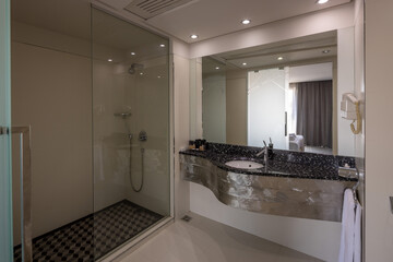 Interior of a luxury hotel bathroom with glass shower cabin