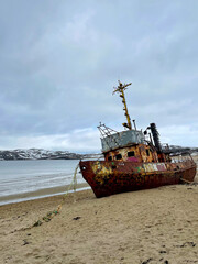 Old fishing schooner in the bay of the Barents Sea, Teriberka, Russia