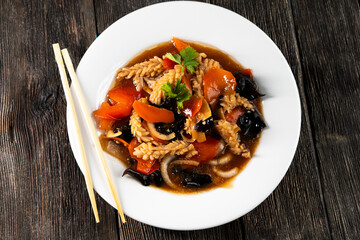 squid with vegetables on dark background. Asian food. Chinese cuisine. Seafood. Vegetables