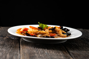 squid with vegetables on dark background. Asian food. Chinese cuisine. Seafood. Vegetables