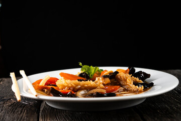 squid with vegetables on dark background. Asian food. Chinese cuisine. Seafood. Vegetables