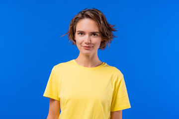 Charming short-haired woman smiles with confident direct gaze. Friendly girl.