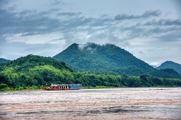 Stormy Skies Over Mekong River Cruise in Luang Prabang, Laos – Dramatic Weather and Jun
