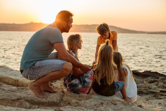 Family playing together seaside.
Family playing together seaside and having a good time with their children's. Lots of love and fun, at a beautiful golden hours time.