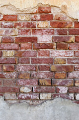 Showcases aged red bricks closely with visible wear and tear, featuring rustic texture and crumbling mortar. Exposed edges reveal patches of white efflorescence and shades of red, brown, and beige.
