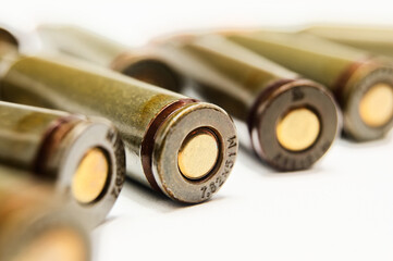 Rifle ammunition showcases its details in close-up view, brass tips and caliber markings gleam on...