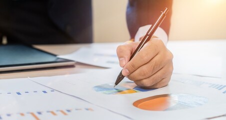 Naklejka premium Businessman Analyzing Financial Data with Graphs.