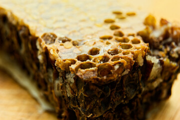 Homemade granola bar showcases dense texture and clusters of chopped nuts, seeds, and dried fruits,...