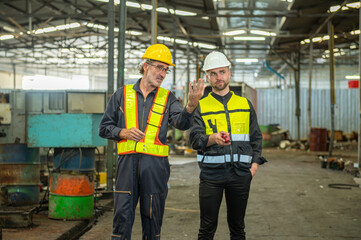 Two professional engineer worker technician assistant in helmet inspection check old machine...