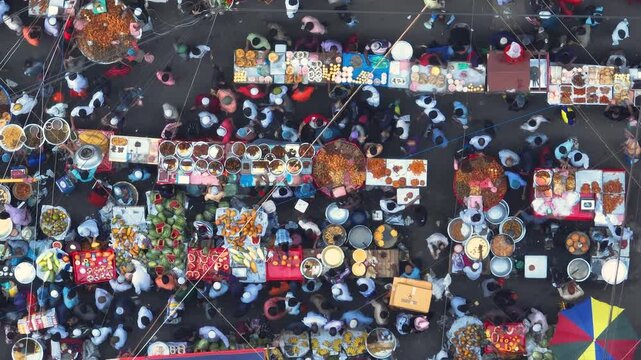 Dhaka, Bangladesh - 23 August 2025: Aerial view of bustling food stalls create a vibrant tapestry of colors amidst the throng of people.