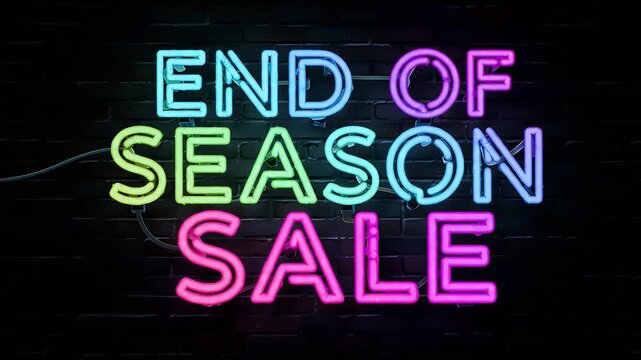 A vibrant neon sign advertising an end-of-season sale. The sign features the words 'END OF SEASON SALE' in multicolored neon lettering against a dark brick wall background