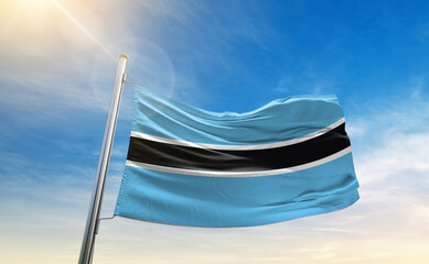 A vivid collection of national flags fluttering under the sunlit sky, representing the colors and...