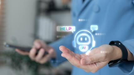 Close-up hand holding hologram AI chatbot assistant with speech bubble help icon. Concept of artificial intelligence, customer support, virtual assistant, digital service, and technology innovation.