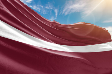 A vivid collection of national flags fluttering under the sunlit sky, representing the colors and pride of diverse nations around the world.