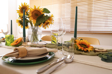 Elegant table serving with plates, folded napkin and beautiful sunflowers