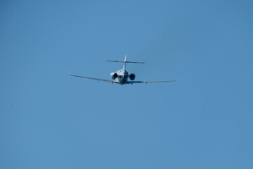 Airplane in the blue sky, close-up view of the plane. Aircraft soaring through the clear sky, detailed view of the plane.