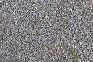 Rough gray gravel as textured background surface, natural stone texture for construction or...