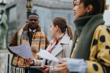 A diverse group of people conversing outdoors, holding documents and wearing stylish winter...