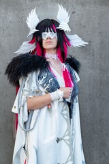 Obraz premium Elegant Fantasy Cosplay with Winged Headpiece, Mask, and Flowing White Outfit