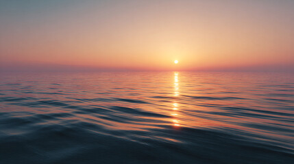 Obraz premium A serene sunset over the ocean with soft reflections and a warm gradient sky, creating a peaceful, calm atmosphere.