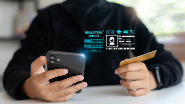 Hand holding a smartphone and a credit card with a hologram login screen for online education. Concept of digital payment, e-learning platform, online study access, and modern education technology.