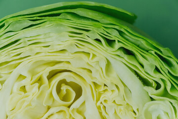 Halved cabbage top view flat lay over green background